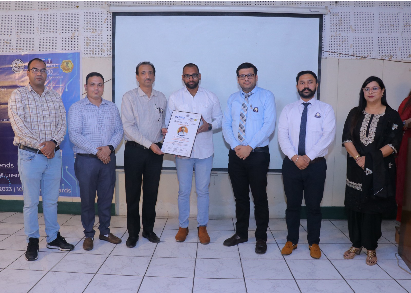 Receiving a token of appreciation at a technical institute event